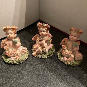Three small miniature angels cute for displaying